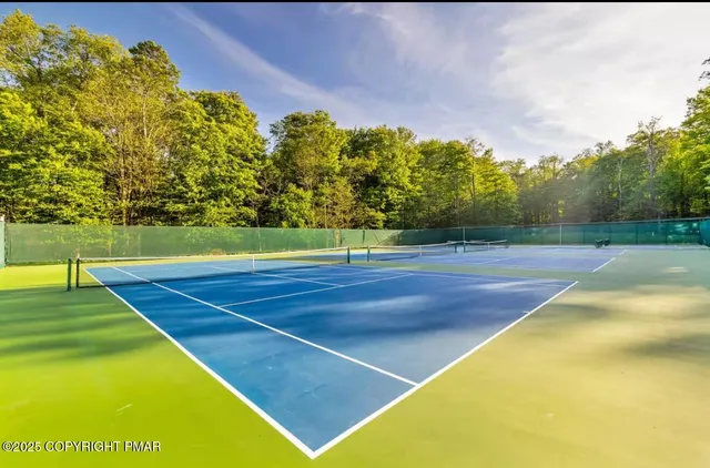a view of a swimming pool with an outdoor space and seating area