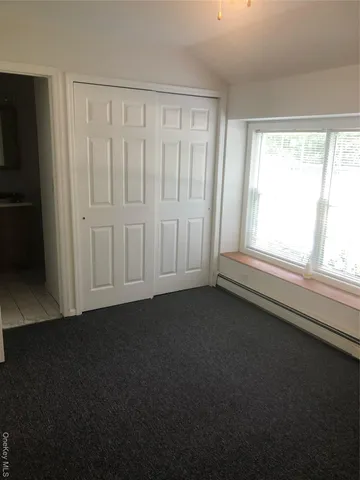 a view of a livingroom with an empty space and a window