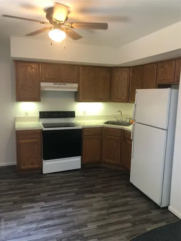 a kitchen with a stove a sink and a refrigerator