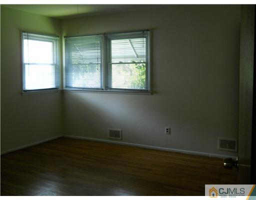 37 Glen Gary Road Middlesex, NJ 08846 - Photo 11 of 15 an empty room with wooden floor and windows