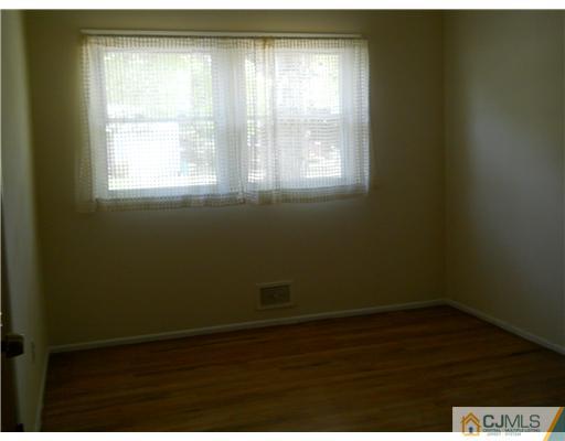 37 Glen Gary Road Middlesex, NJ 08846 - Photo 13 of 15 an empty room with wooden floor and windows