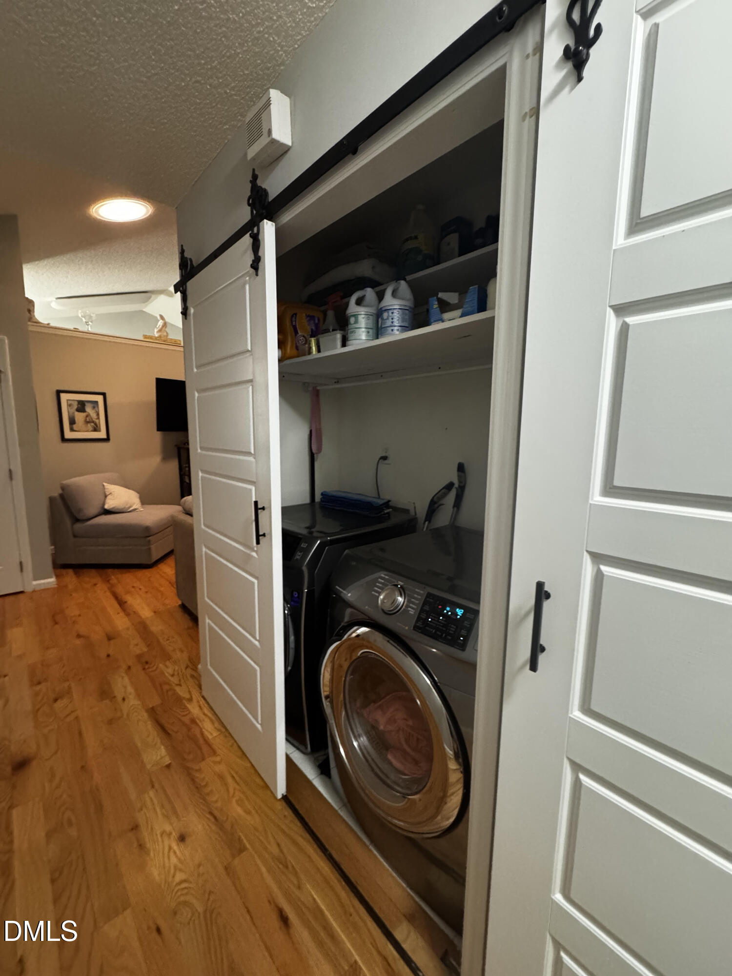 6104 Westborough Drive Raleigh, NC 27612 - Photo 12 of 12 a view of a storage and utility room with washer and dryer