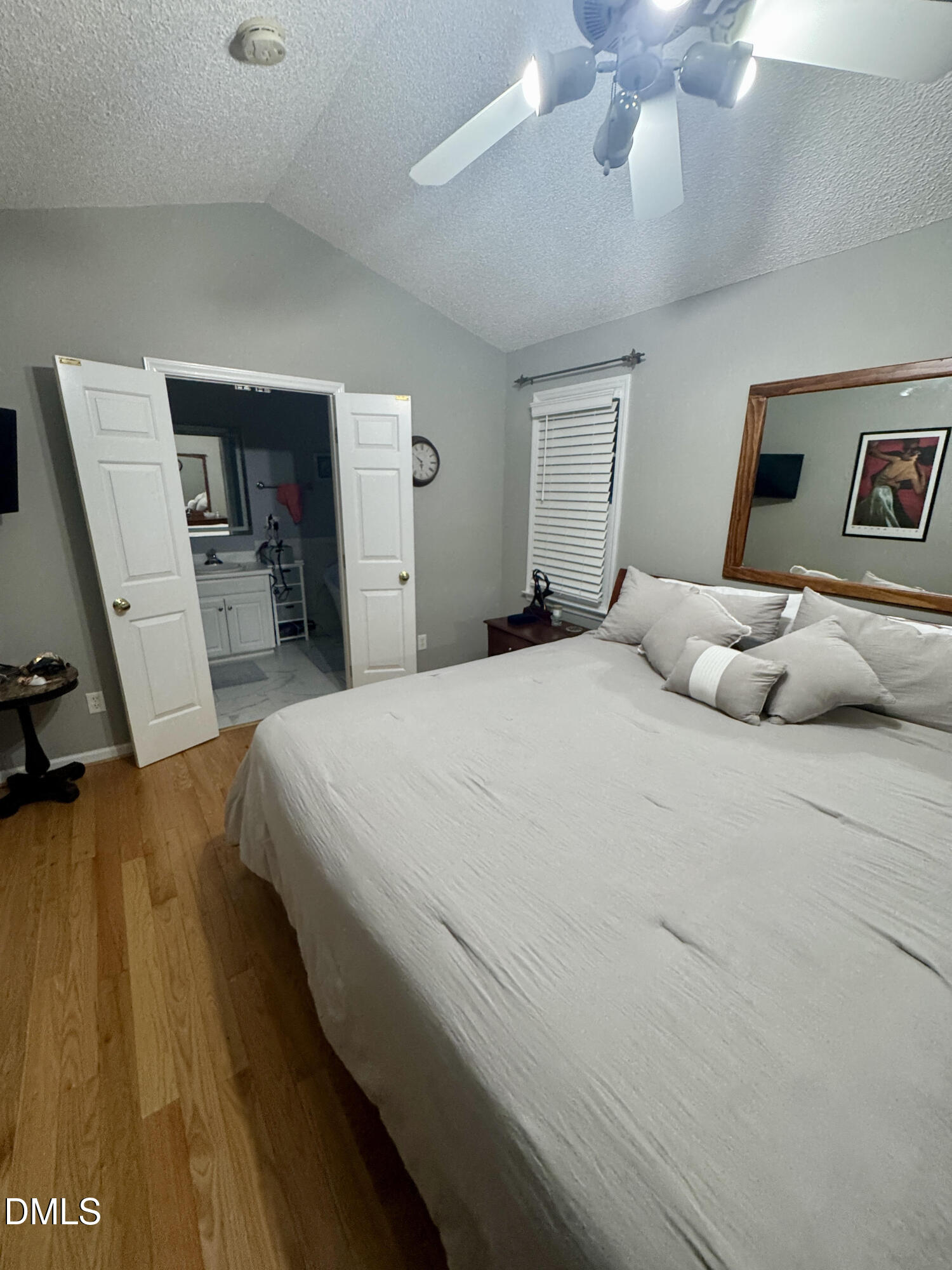 6104 Westborough Drive Raleigh, NC 27612 - Photo 5 of 12 a bedroom with a bed and a chandelier