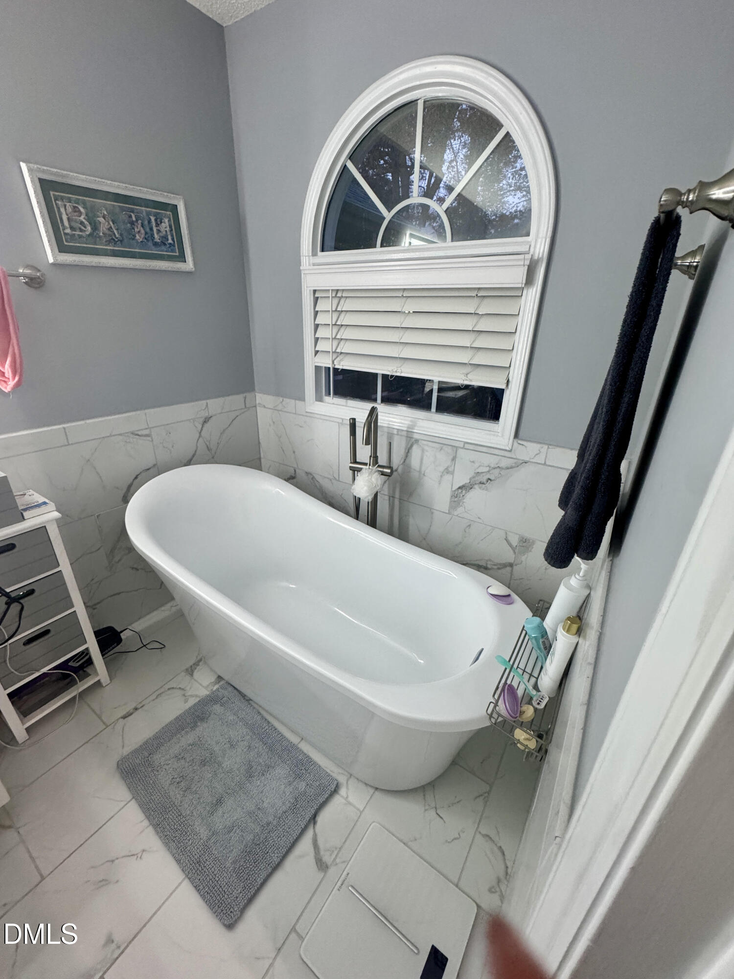 6104 Westborough Drive Raleigh, NC 27612 - Photo 6 of 12 a bath tub sitting next to a blue sink