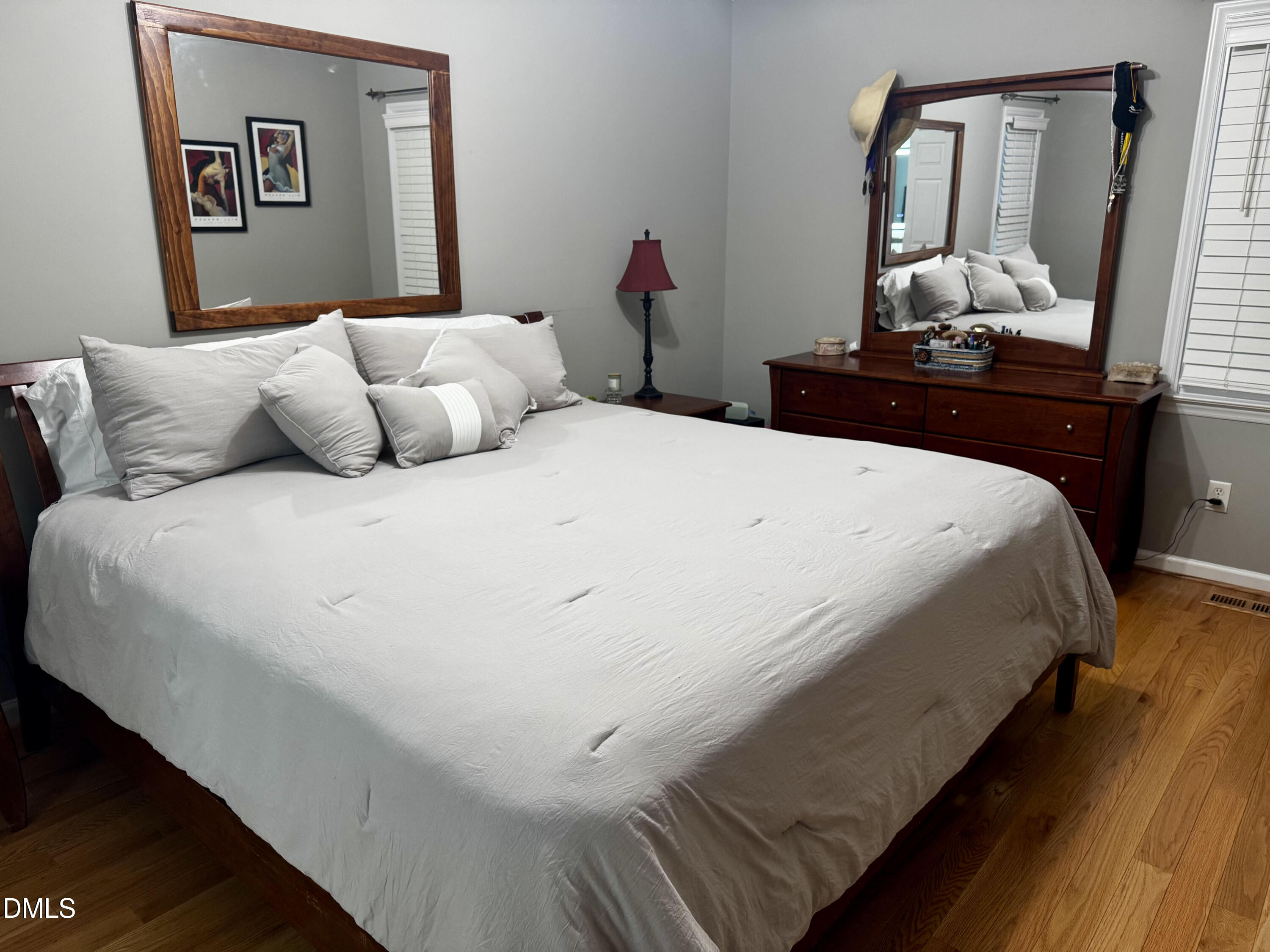 6104 Westborough Drive Raleigh, NC 27612 - Photo 7 of 12 a bedroom with a bed and a mirror on dresser