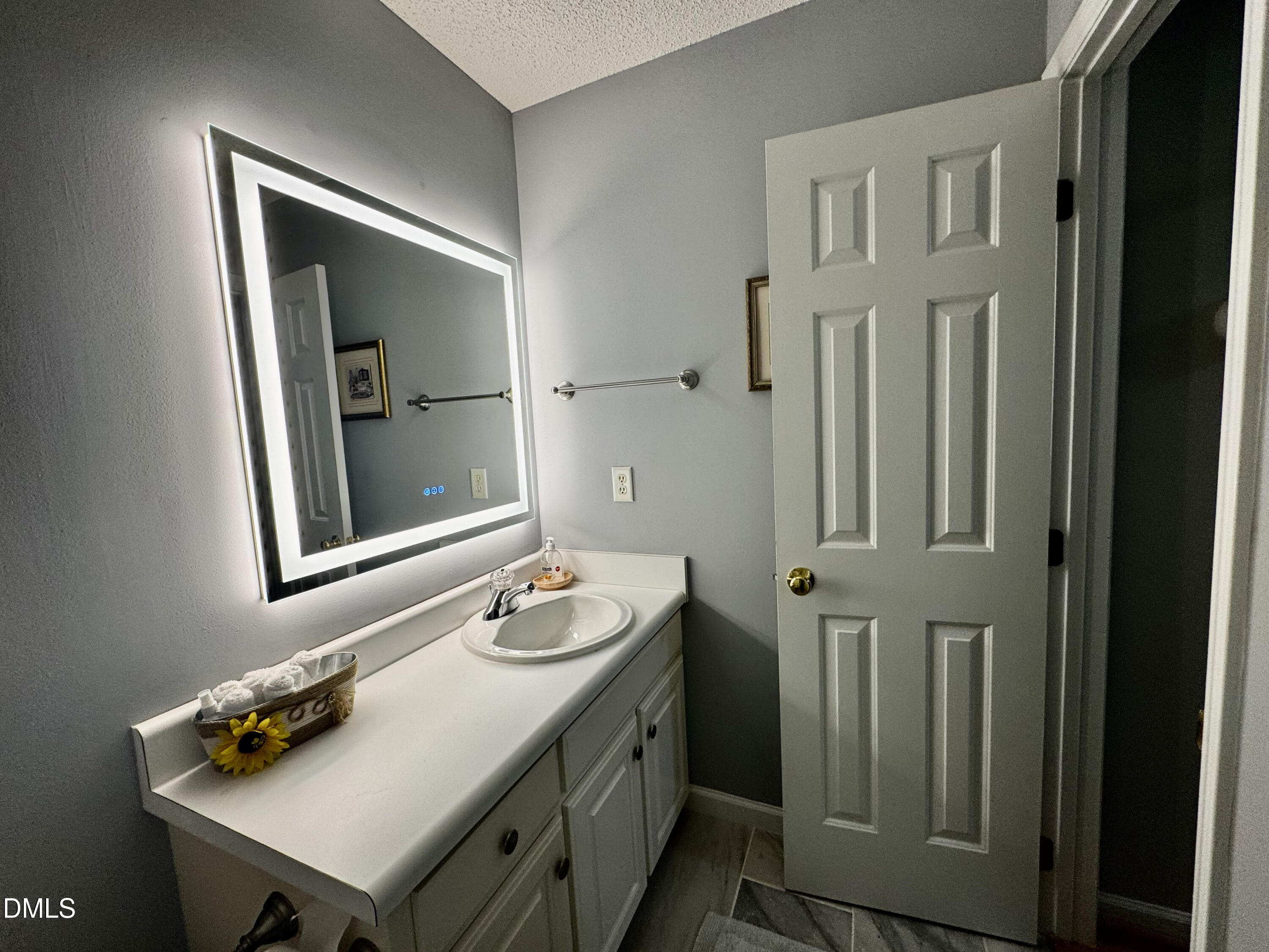 6104 Westborough Drive Raleigh, NC 27612 - Photo 9 of 12 a bathroom with a sink a vanity and a mirror