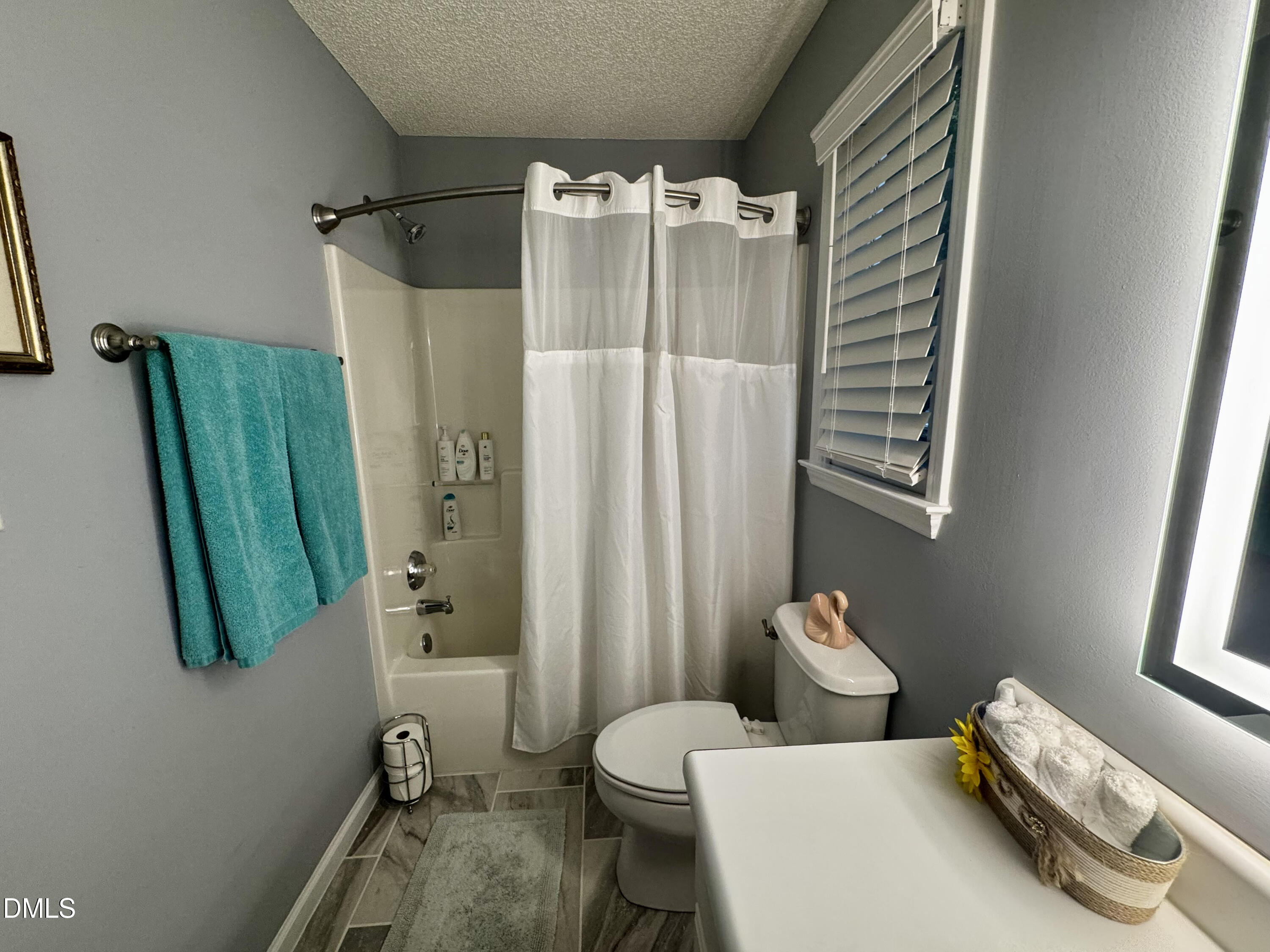 6104 Westborough Drive Raleigh, NC 27612 - Photo 10 of 12 a bathroom with a sink toilet and shower