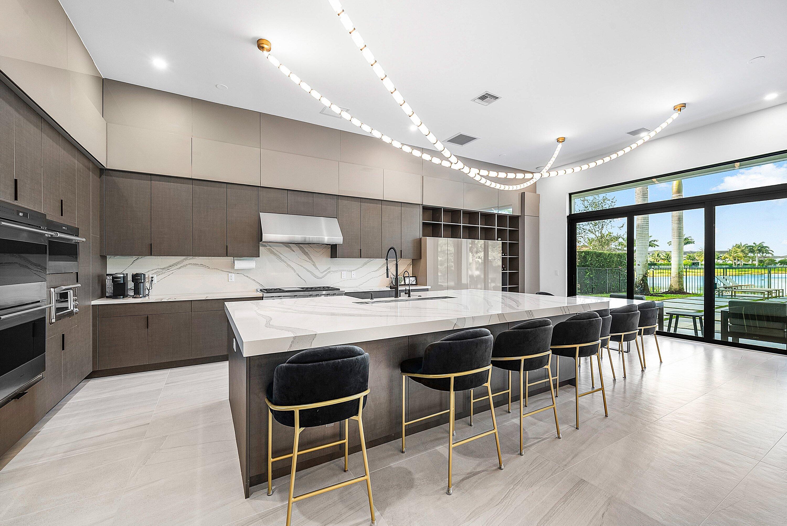 17353 Rosella Road Boca Raton, FL 33496 - Photo 17 of 77 a kitchen with stainless steel appliances granite countertop table chairs sink and stove