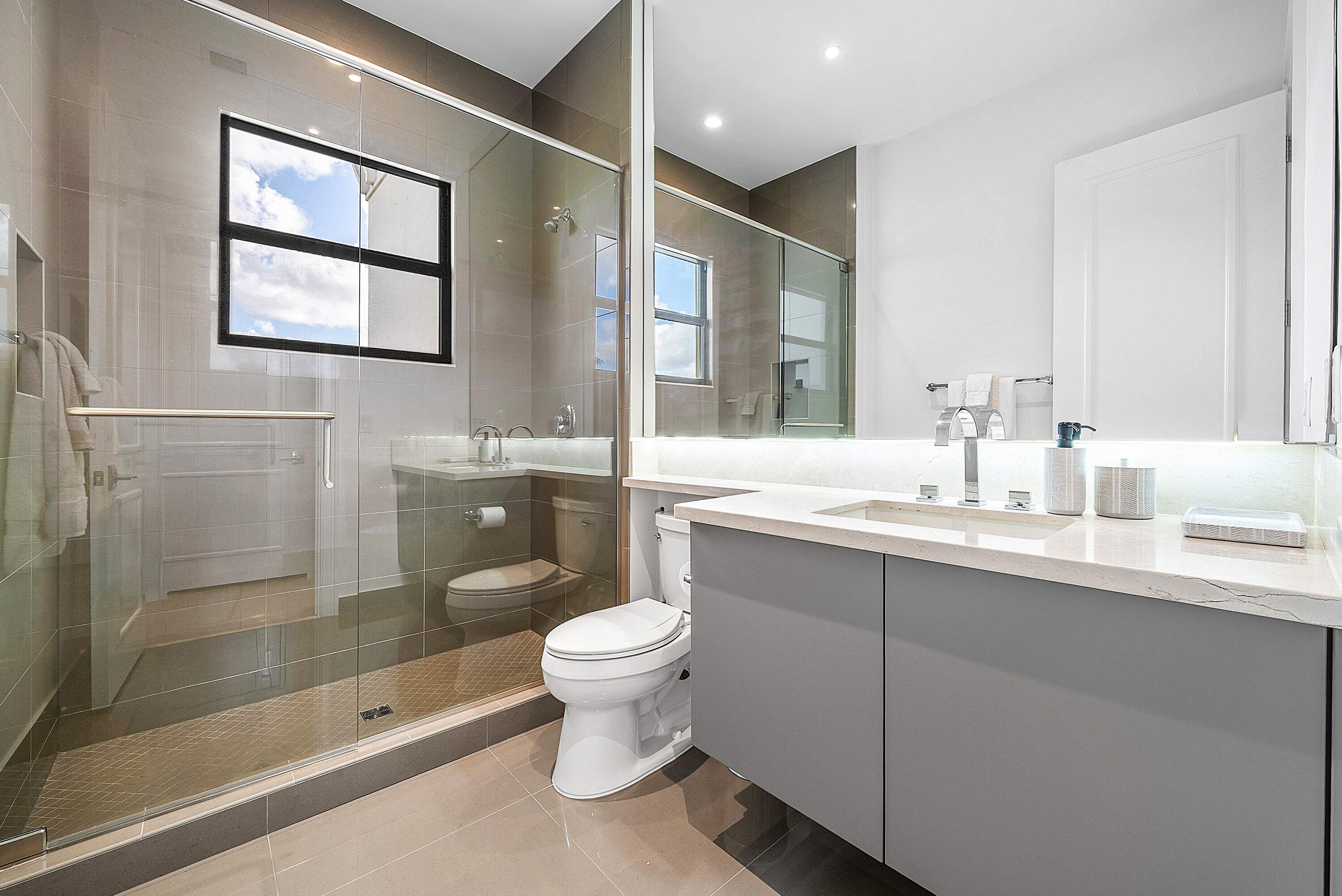 17353 Rosella Road Boca Raton, FL 33496 - Photo 27 of 77 a bathroom with a toilet sink and mirror