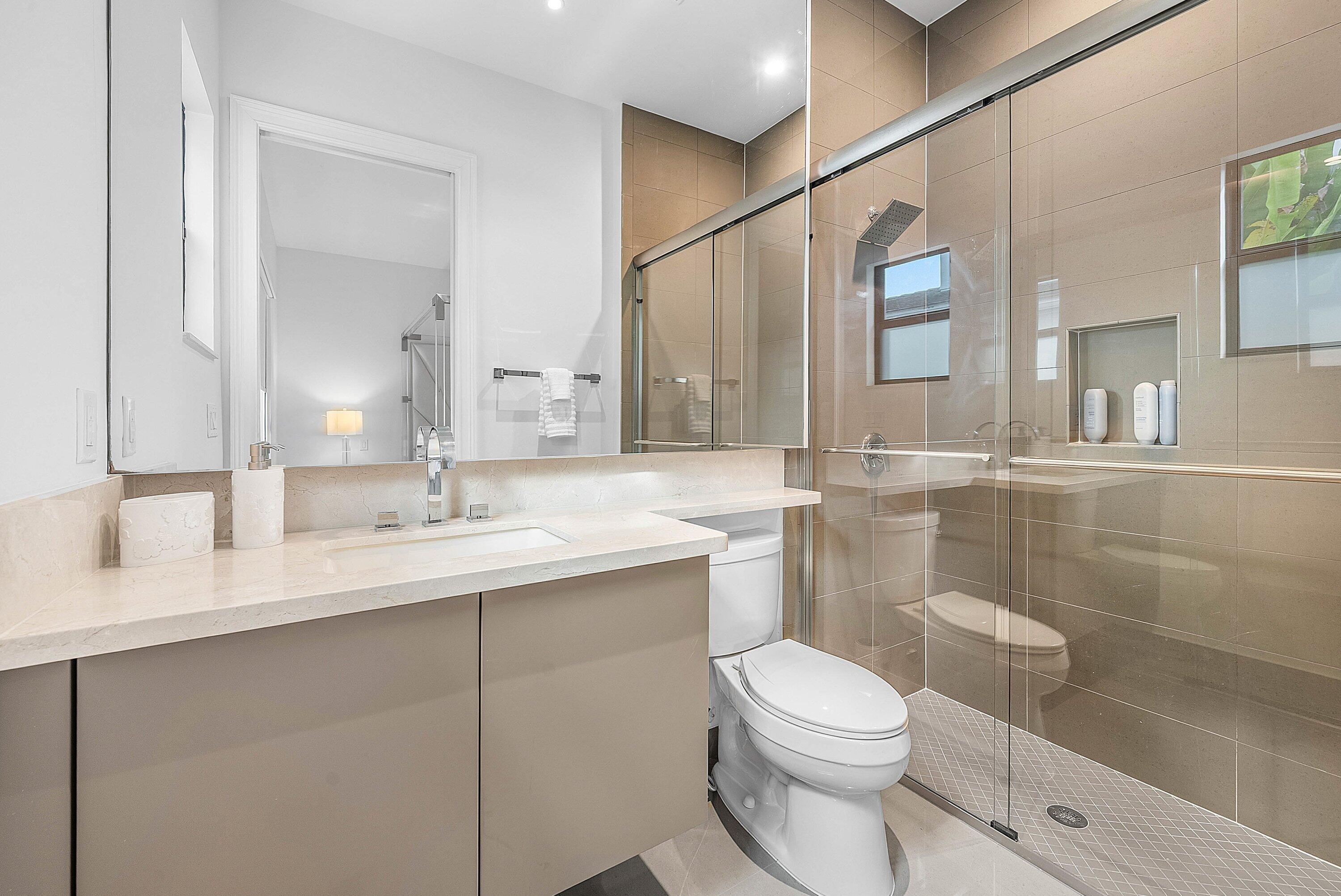 17353 Rosella Road Boca Raton, FL 33496 - Photo 30 of 77 a bathroom with a toilet a sink a mirror a vanity and shower