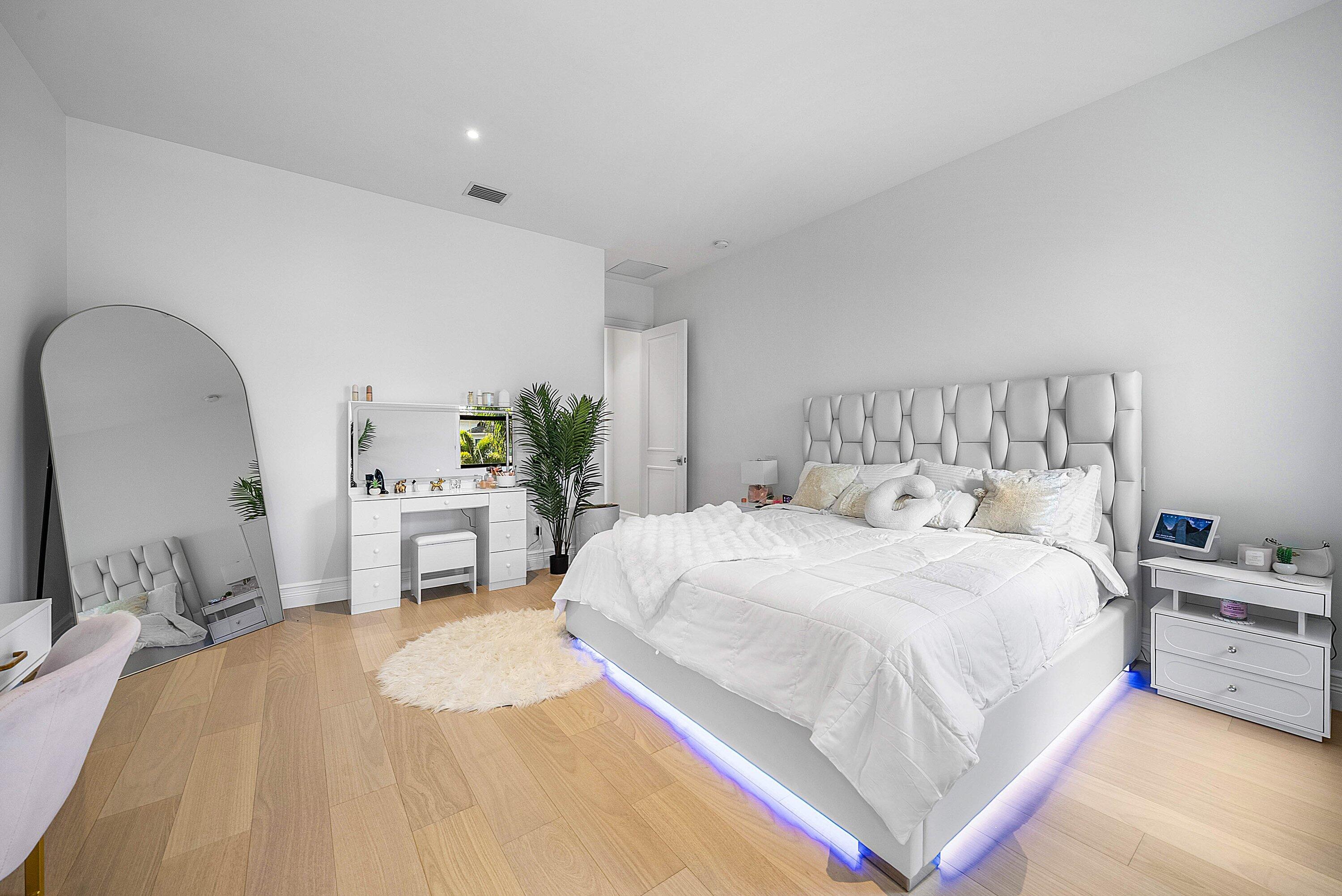 17353 Rosella Road Boca Raton, FL 33496 - Photo 36 of 77 a bedroom with a bed a mirror and potted plant on dresser