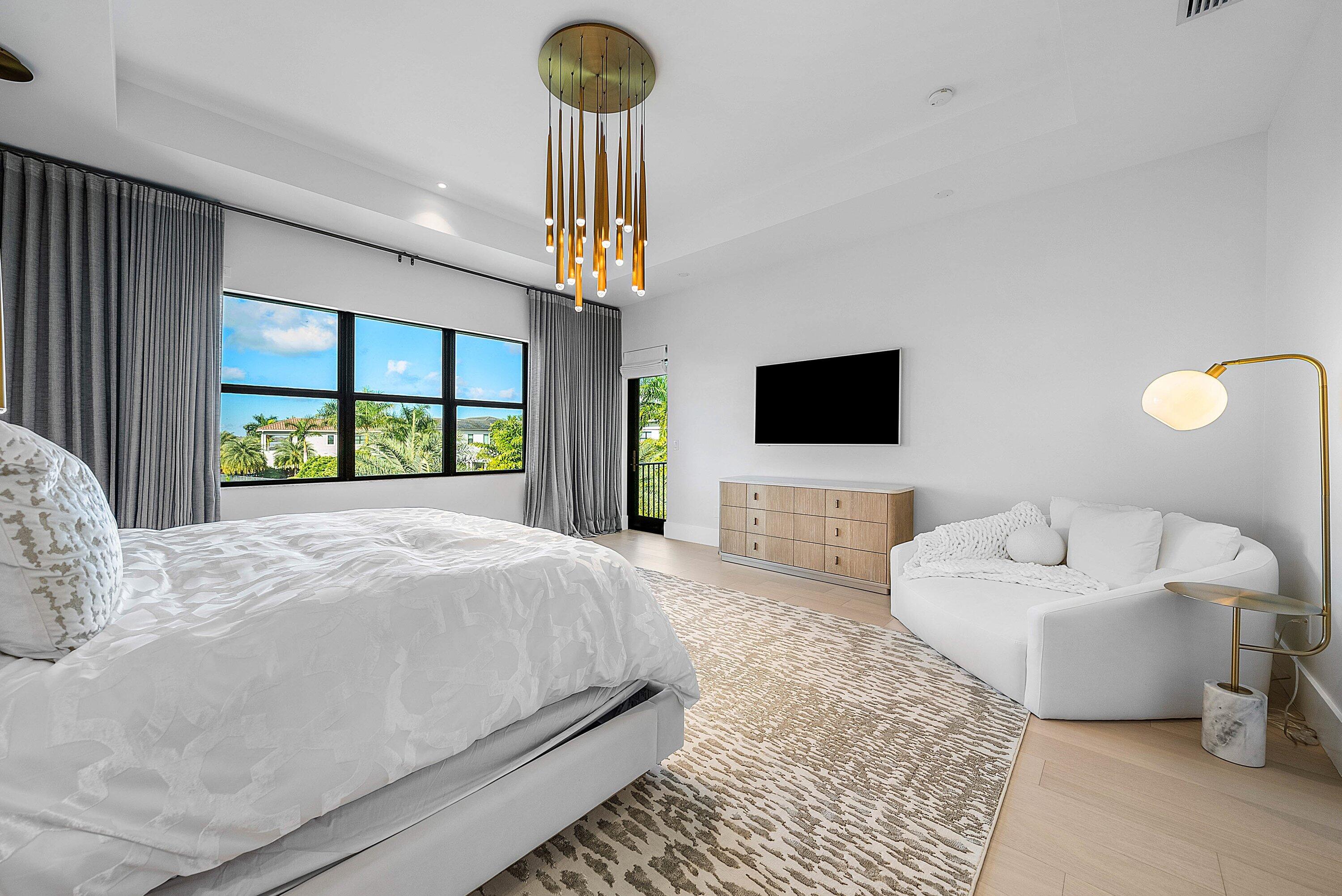 17353 Rosella Road Boca Raton, FL 33496 - Photo 40 of 77 a spacious bedroom with a bed and a flat screen tv