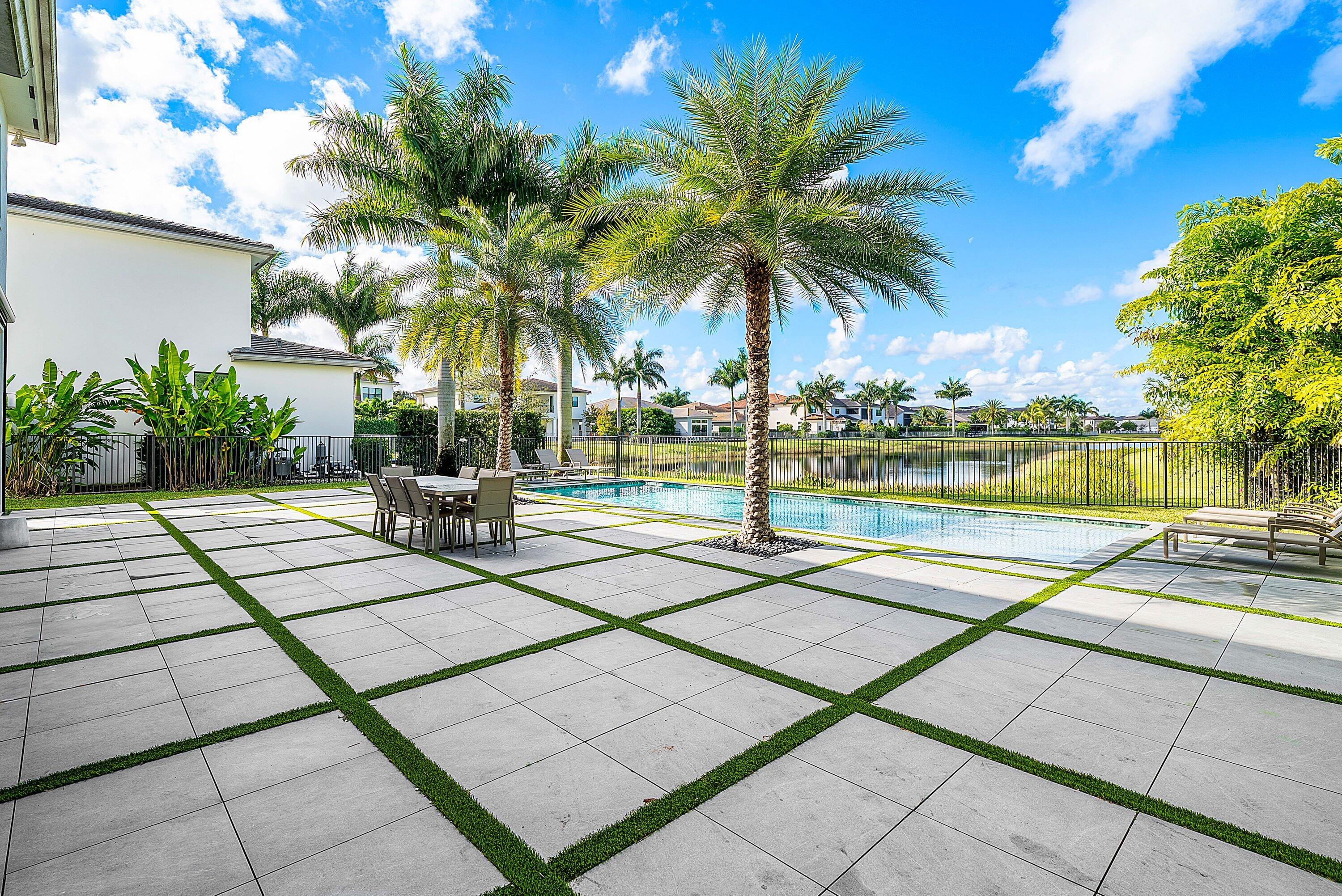 17353 Rosella Road Boca Raton, FL 33496 - Photo 48 of 77 a view of swimming pool with lounge chair and palm trees