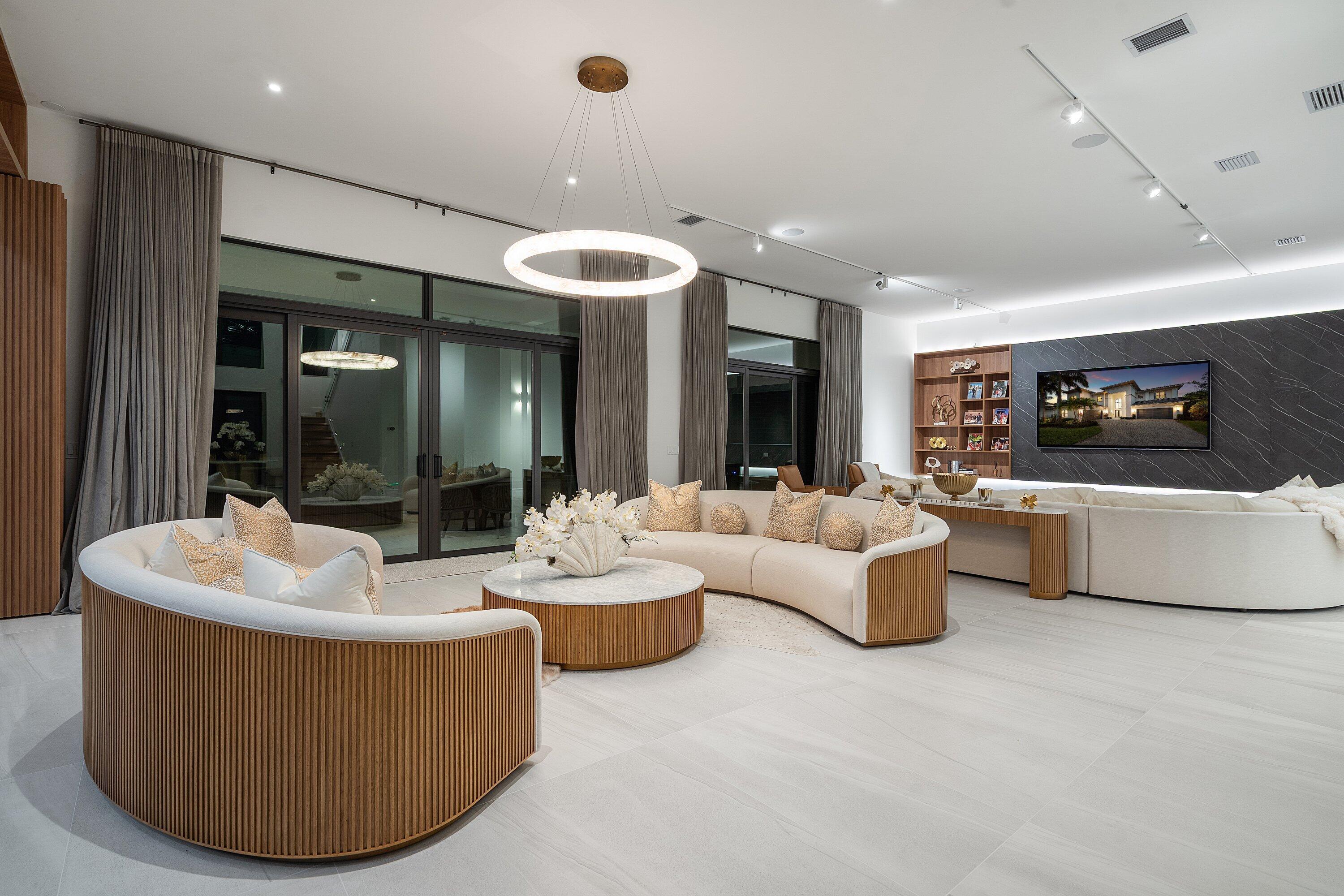 17353 Rosella Road Boca Raton, FL 33496 - Photo 62 of 77 a living room with couches and kitchen view with wooden floor