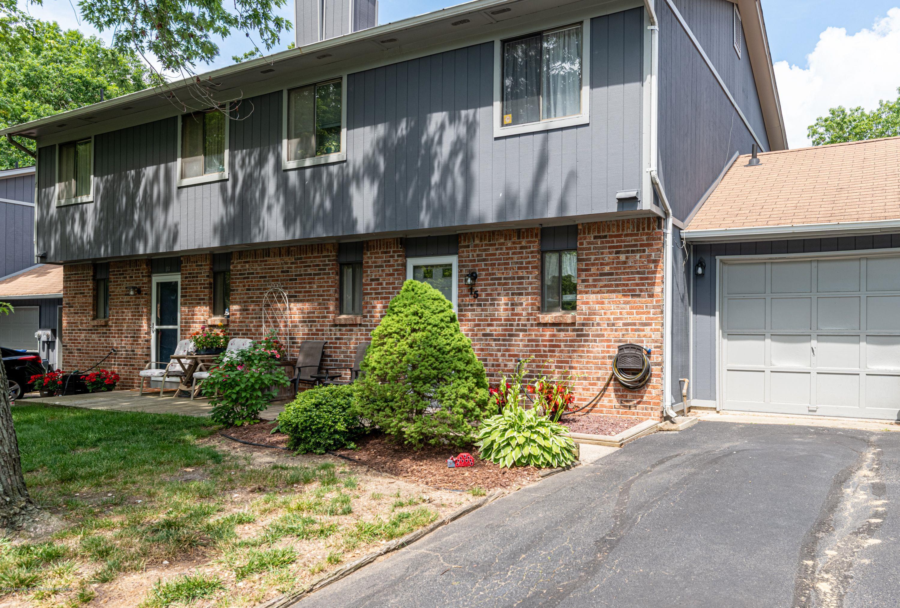 15 Finch Road Howell, NJ 07731 - Photo 1 of 15 a front view of a house with garden