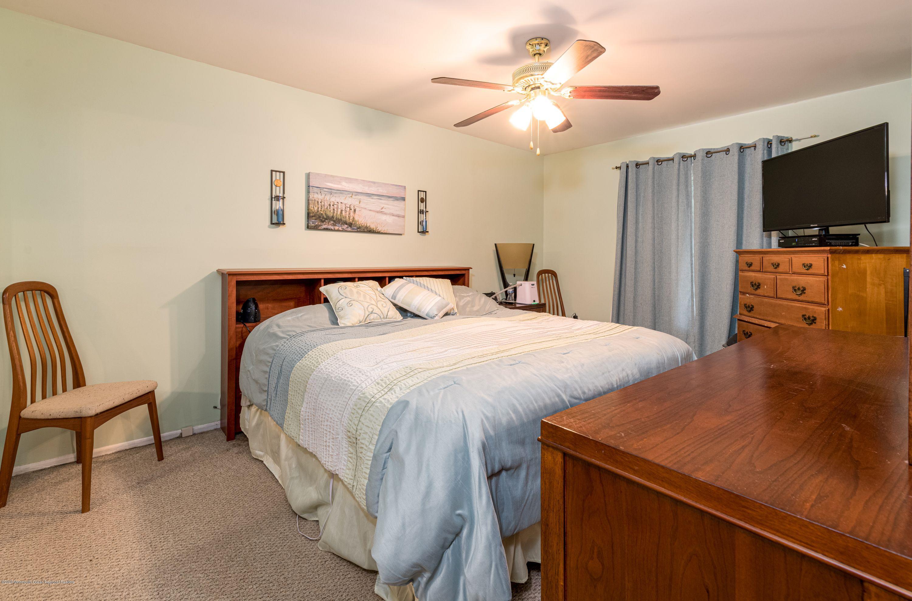 15 Finch Road Howell, NJ 07731 - Photo 12 of 15 a bedroom with a bed and a flat screen tv