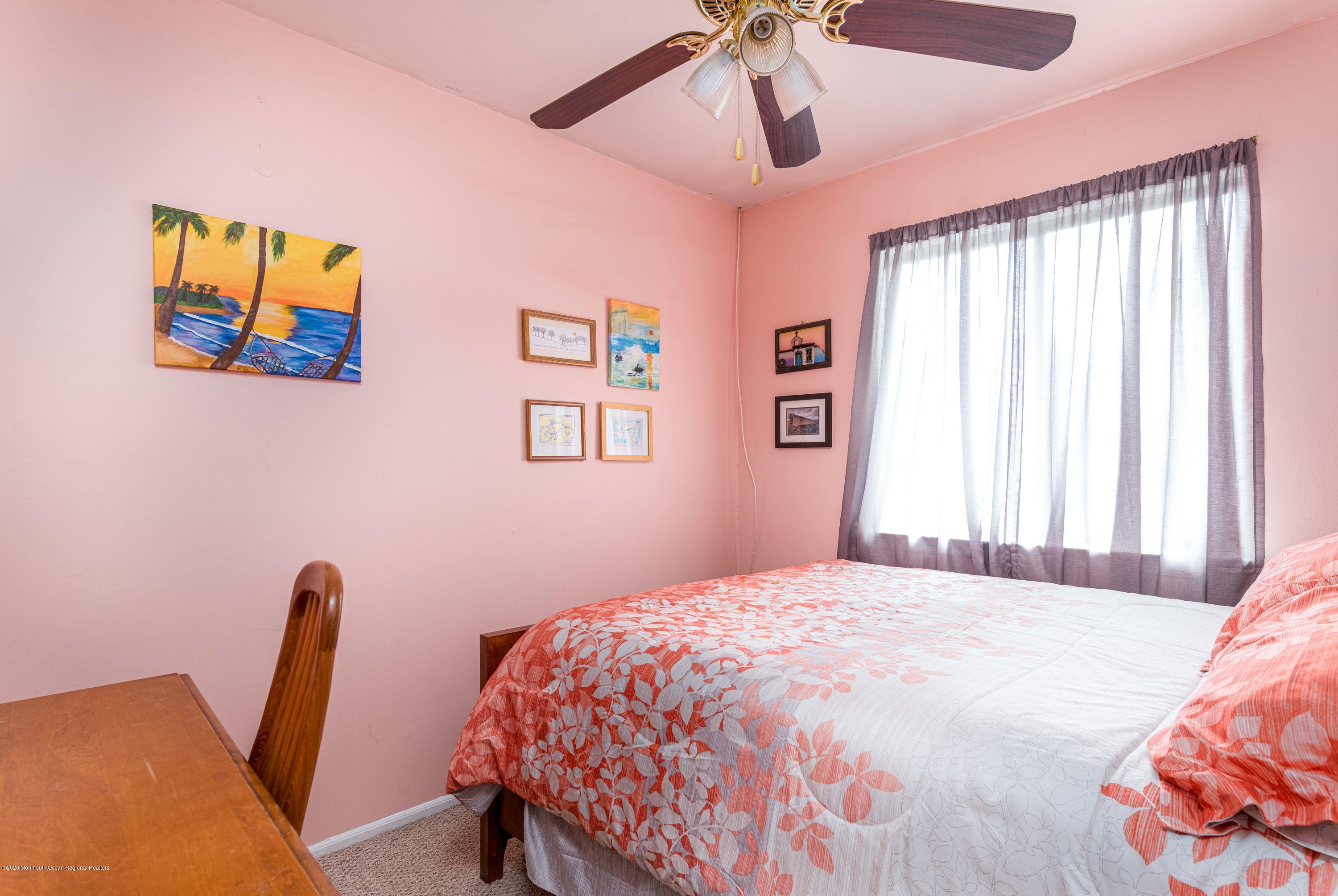 15 Finch Road Howell, NJ 07731 - Photo 13 of 15 a bedroom with a bed a desk and chair next to a window