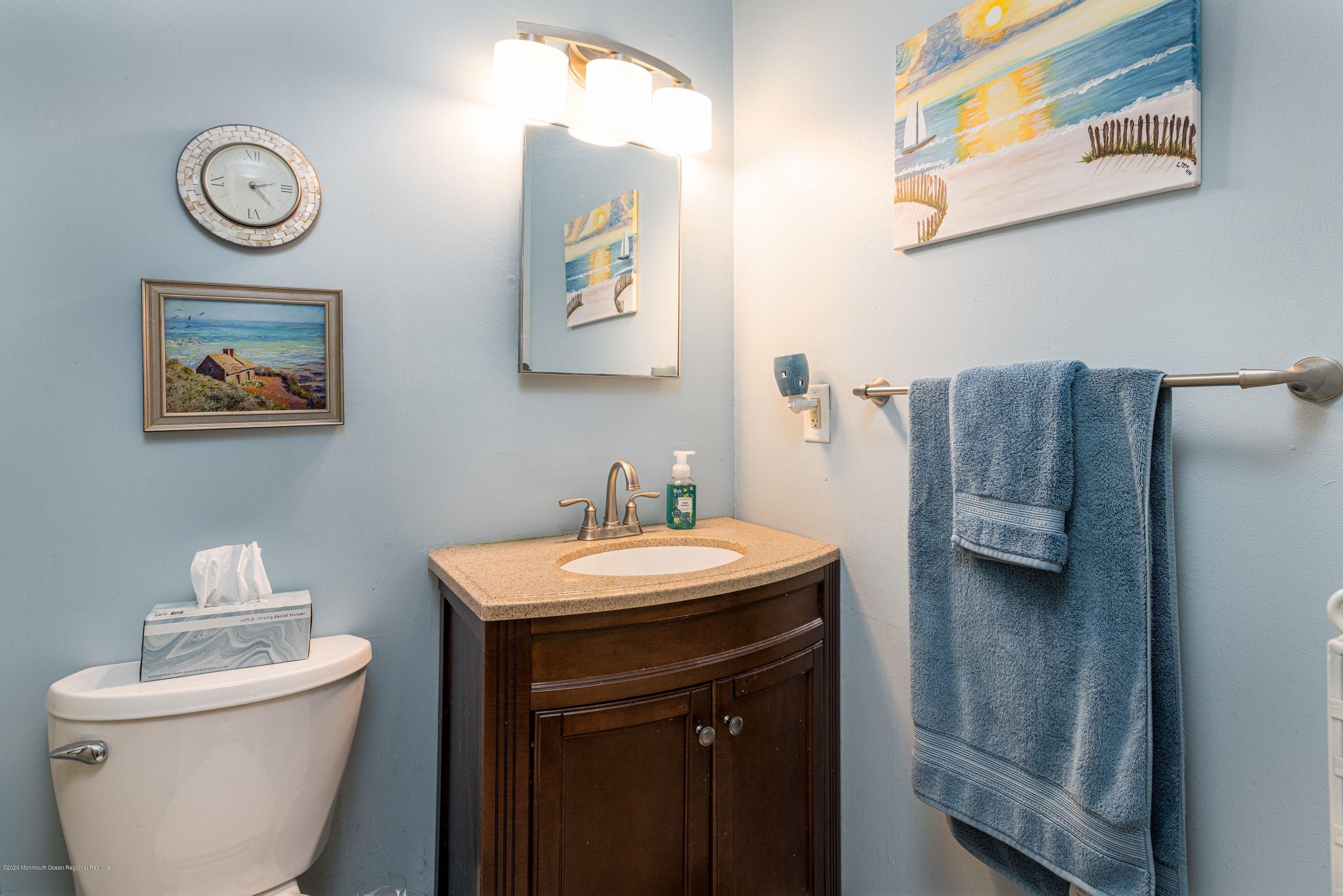 15 Finch Road Howell, NJ 07731 - Photo 15 of 15 a bathroom with a toilet a sink and mirror