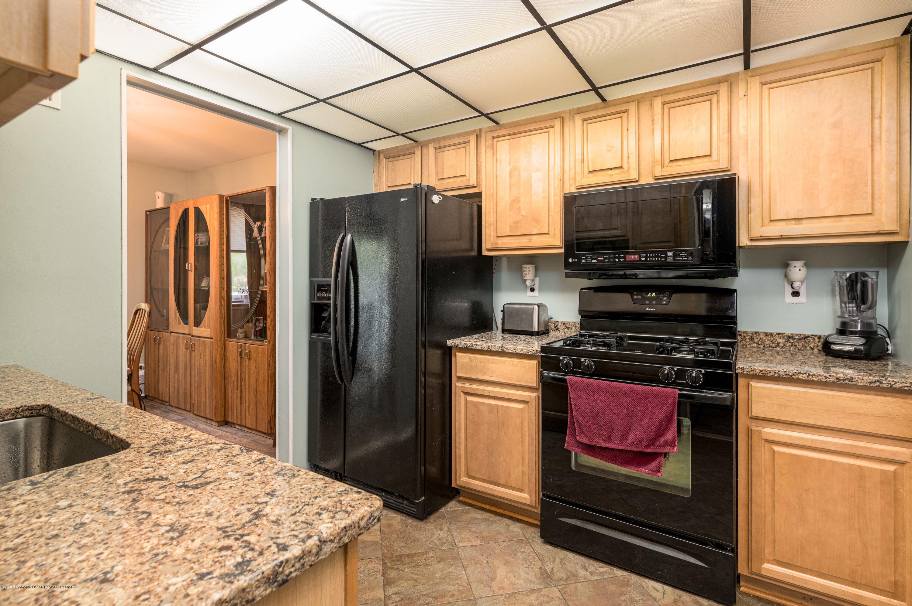 15 Finch Road Howell, NJ 07731 - Photo 8 of 15 a kitchen with stainless steel appliances granite countertop a refrigerator a stove top oven a sink and dishwasher