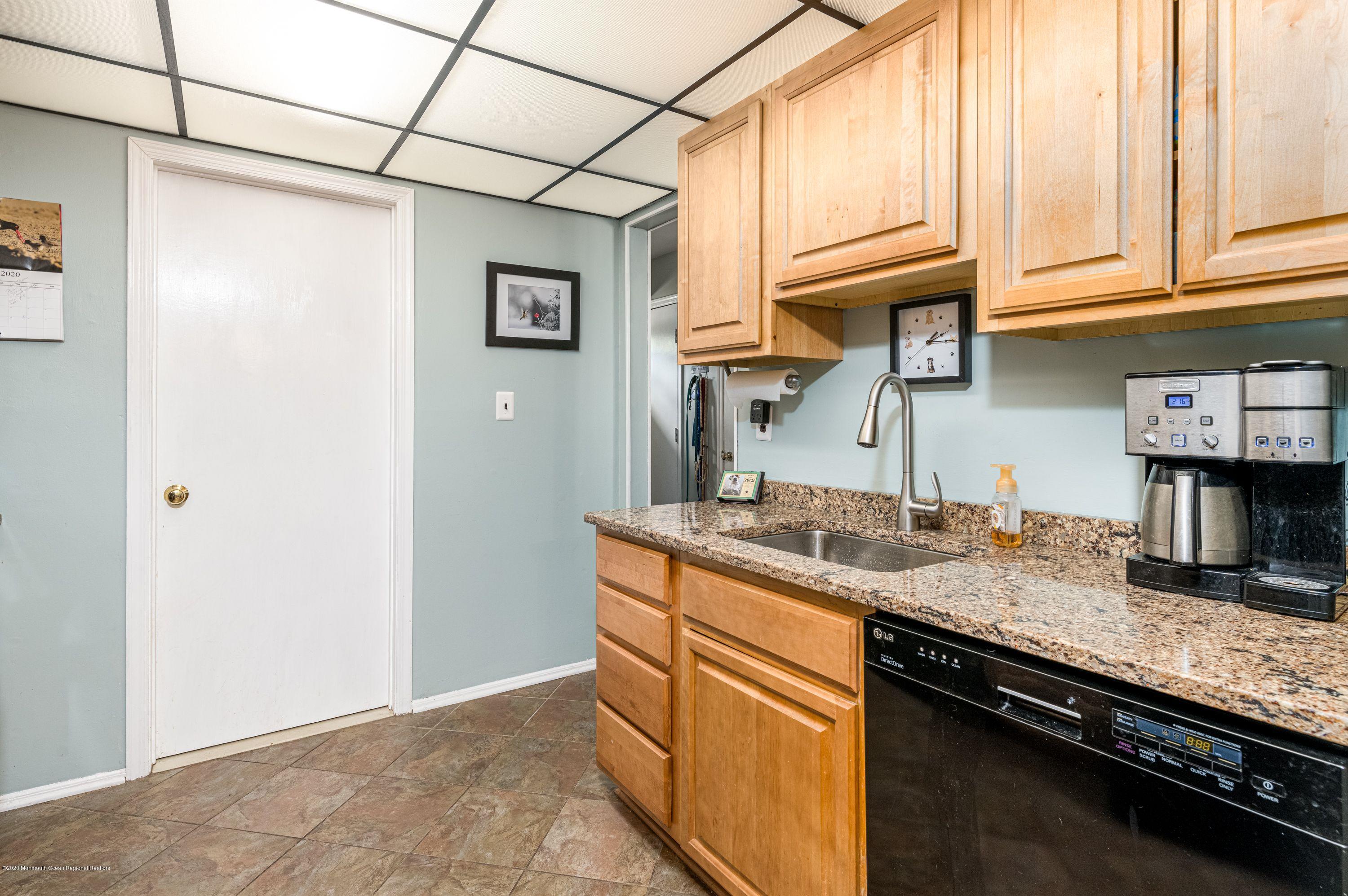 15 Finch Road Howell, NJ 07731 - Photo 9 of 15 a kitchen with stainless steel appliances granite countertop a sink and a refrigerator