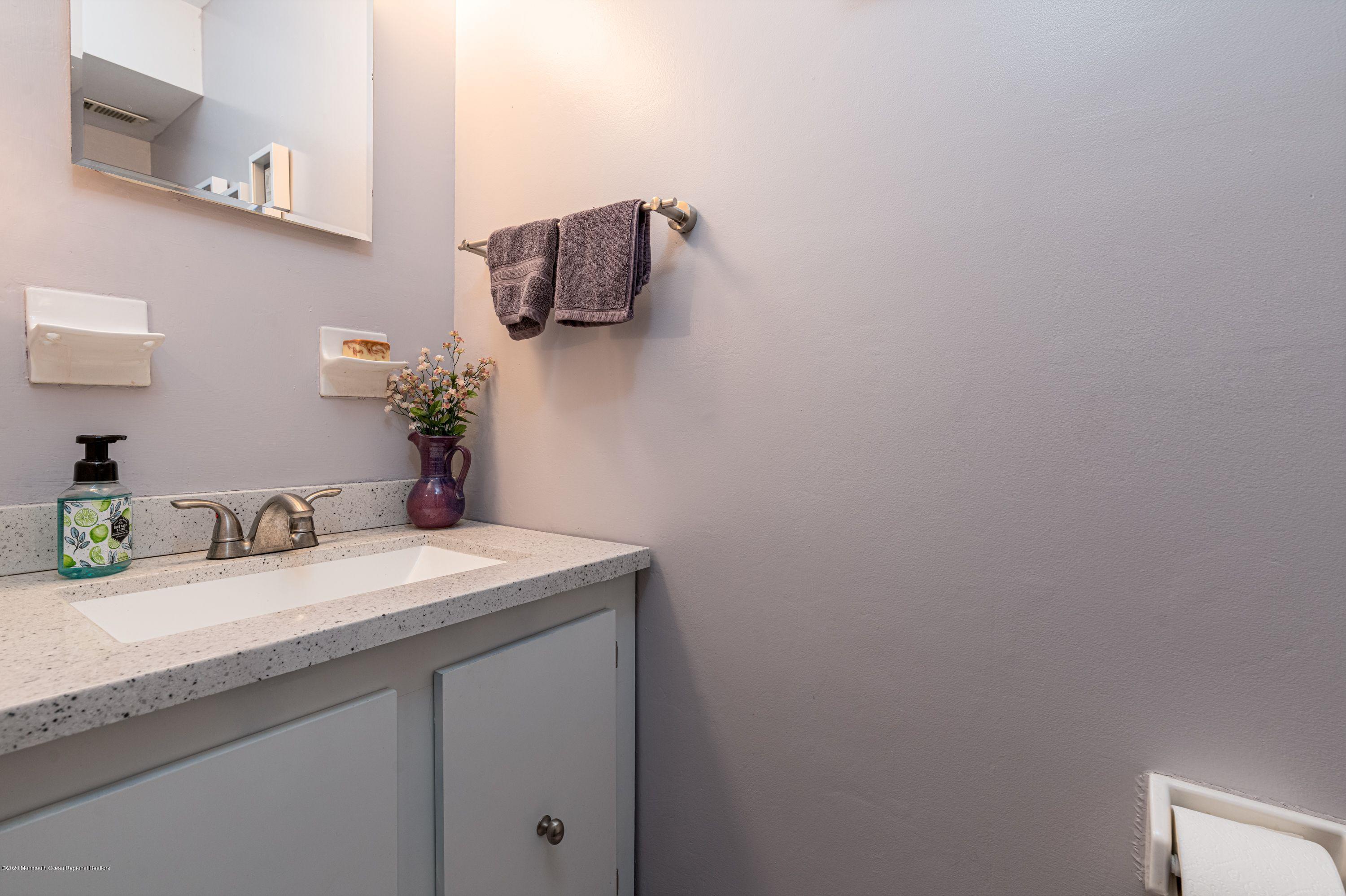 15 Finch Road Howell, NJ 07731 - Photo 10 of 15 a bathroom with a granite countertop sink and a mirror