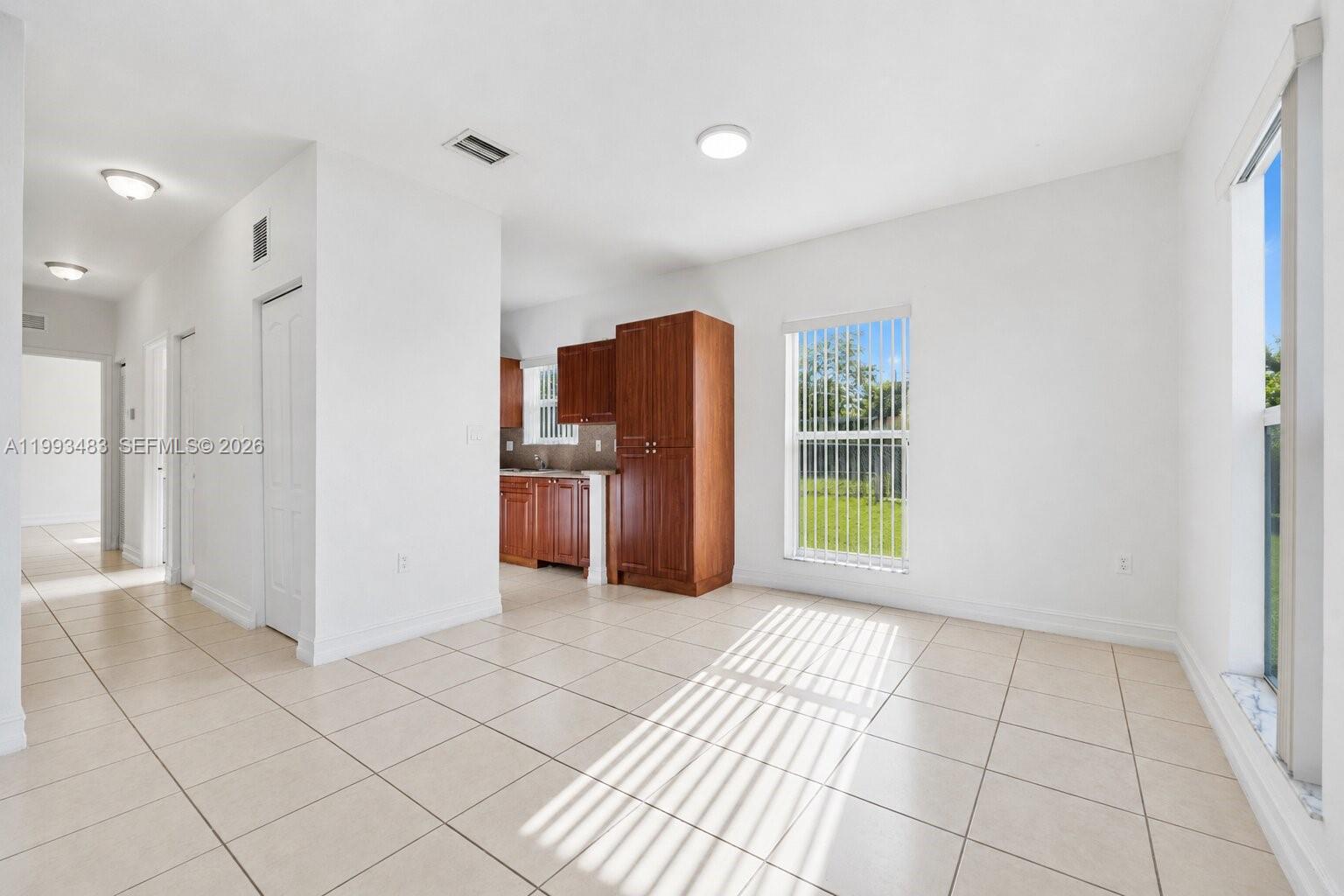 10357 Southwest 178th Street, Unit 10357 Miami, FL 33157 - Photo 9 of 25 a view of a kitchen with furniture and an empty room