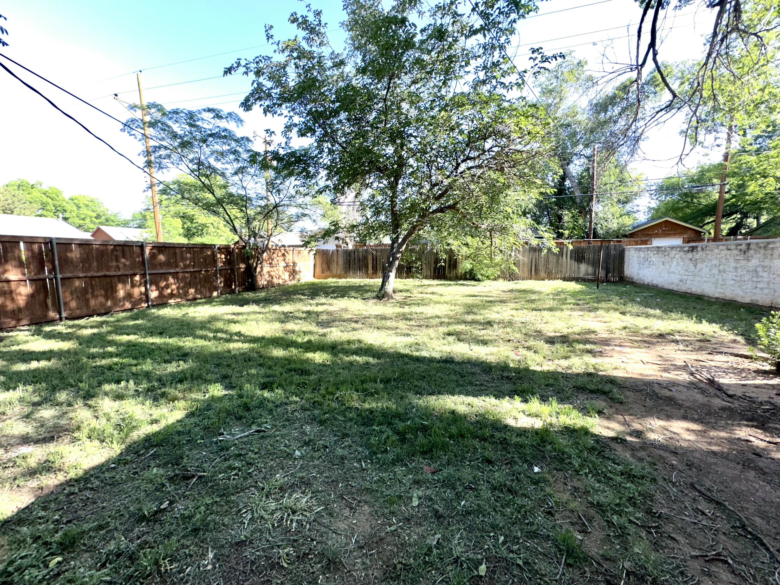 3012 22nd Street Lubbock, TX 79410 - Photo 7 of 11 a view of a big yard with a tree