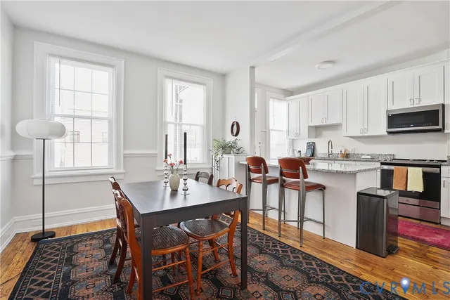 a view of a dining room with furniture and window
