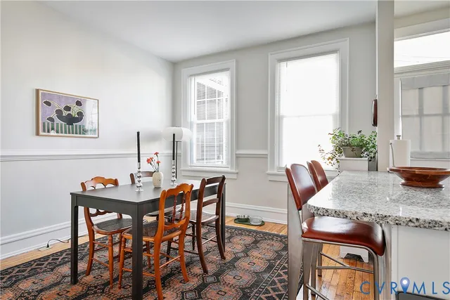 a kitchen with granite countertop stainless steel appliances a sink a stove top oven a counter space and cabinets