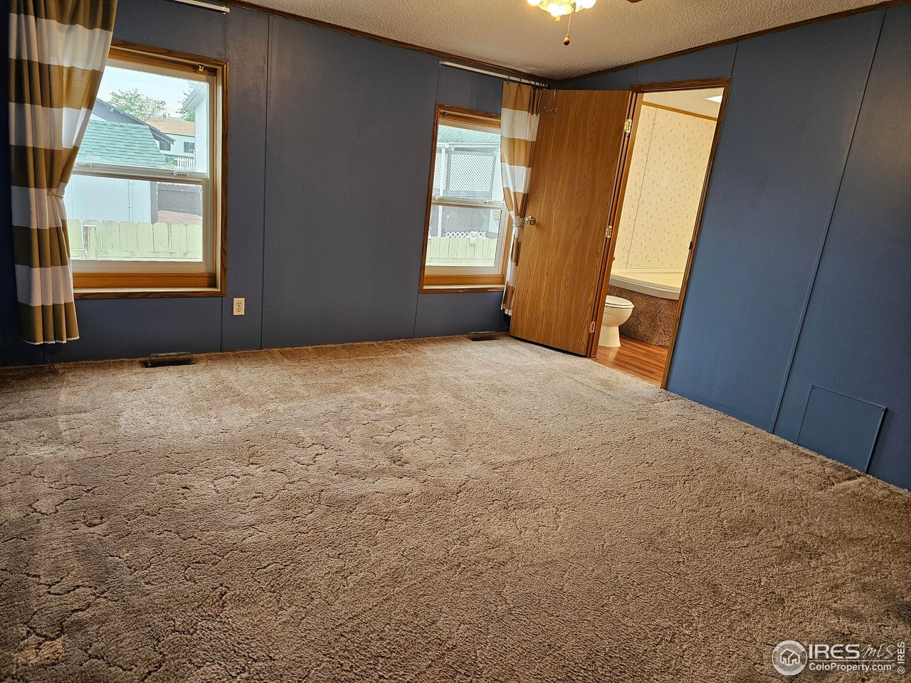 1912 Fillmore Street Sterling, CO 80751 - Photo 17 of 27 Nice windows for natural light in the primary bedroom