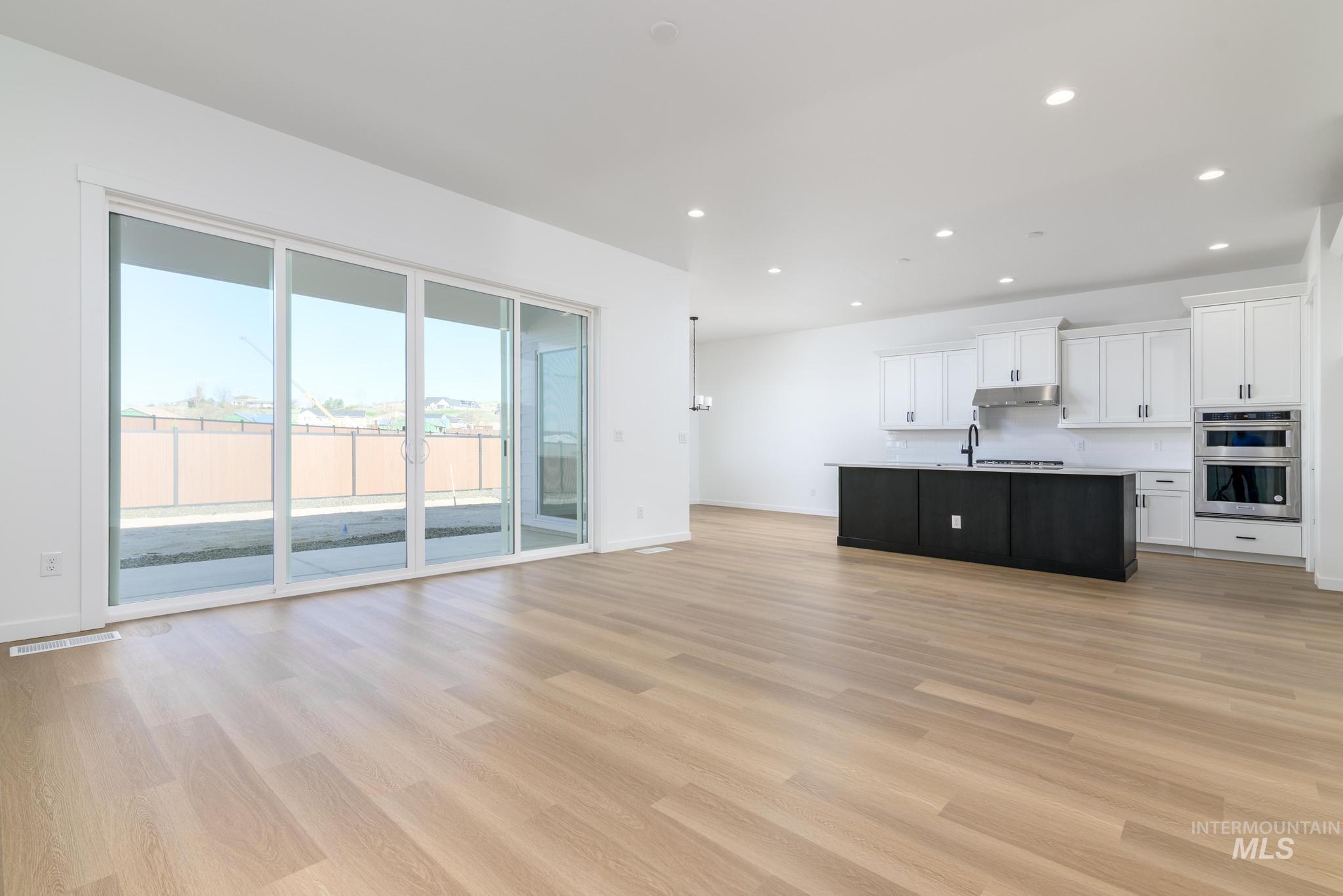 5404 Sparky Avenue Caldwell, ID 83607 - Photo 3 of 18 Unfurnished living room with light wood finished floors and recessed lighting