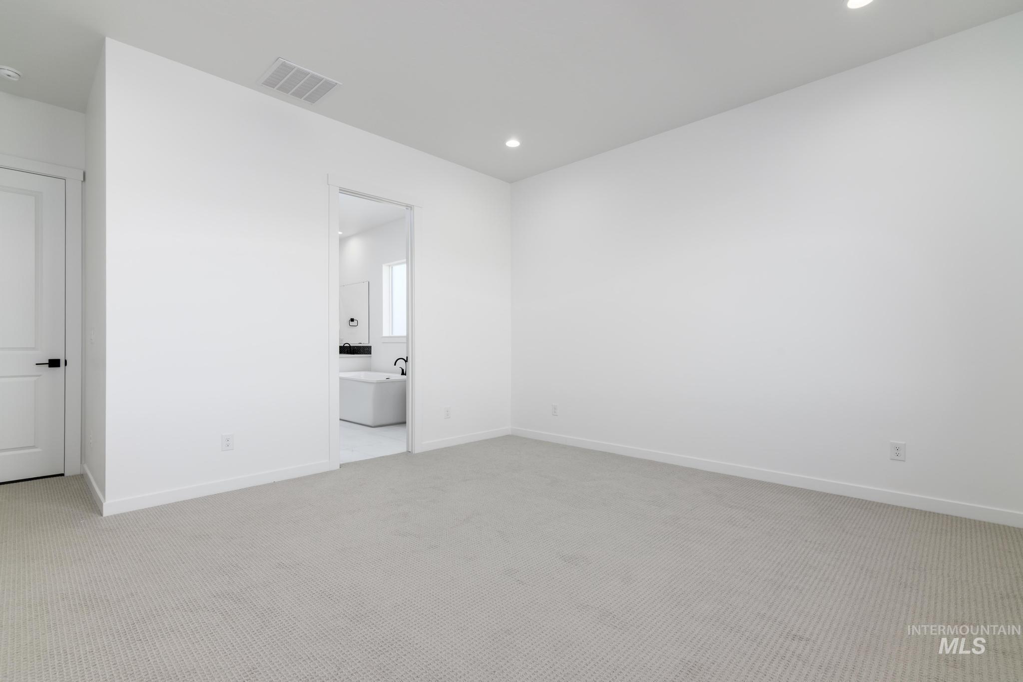 5404 Sparky Avenue Caldwell, ID 83607 - Photo 6 of 18 Spare room with light colored carpet and recessed lighting