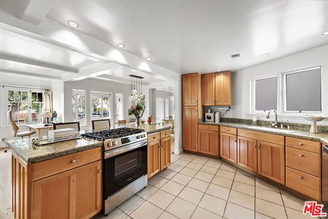 a kitchen with stainless steel appliances granite countertop a stove sink and cabinets