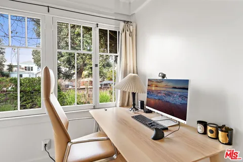 a bedroom with furniture and a window
