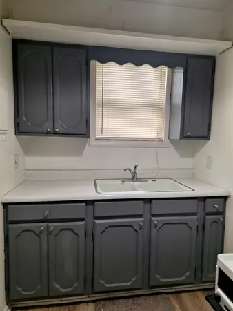 a sink with wooden cabinets