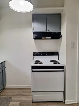 a stove top oven sitting inside of a kitchen