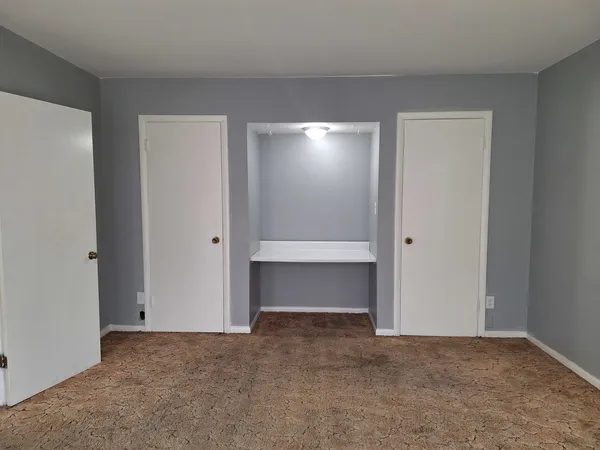a view of an empty room with a closet
