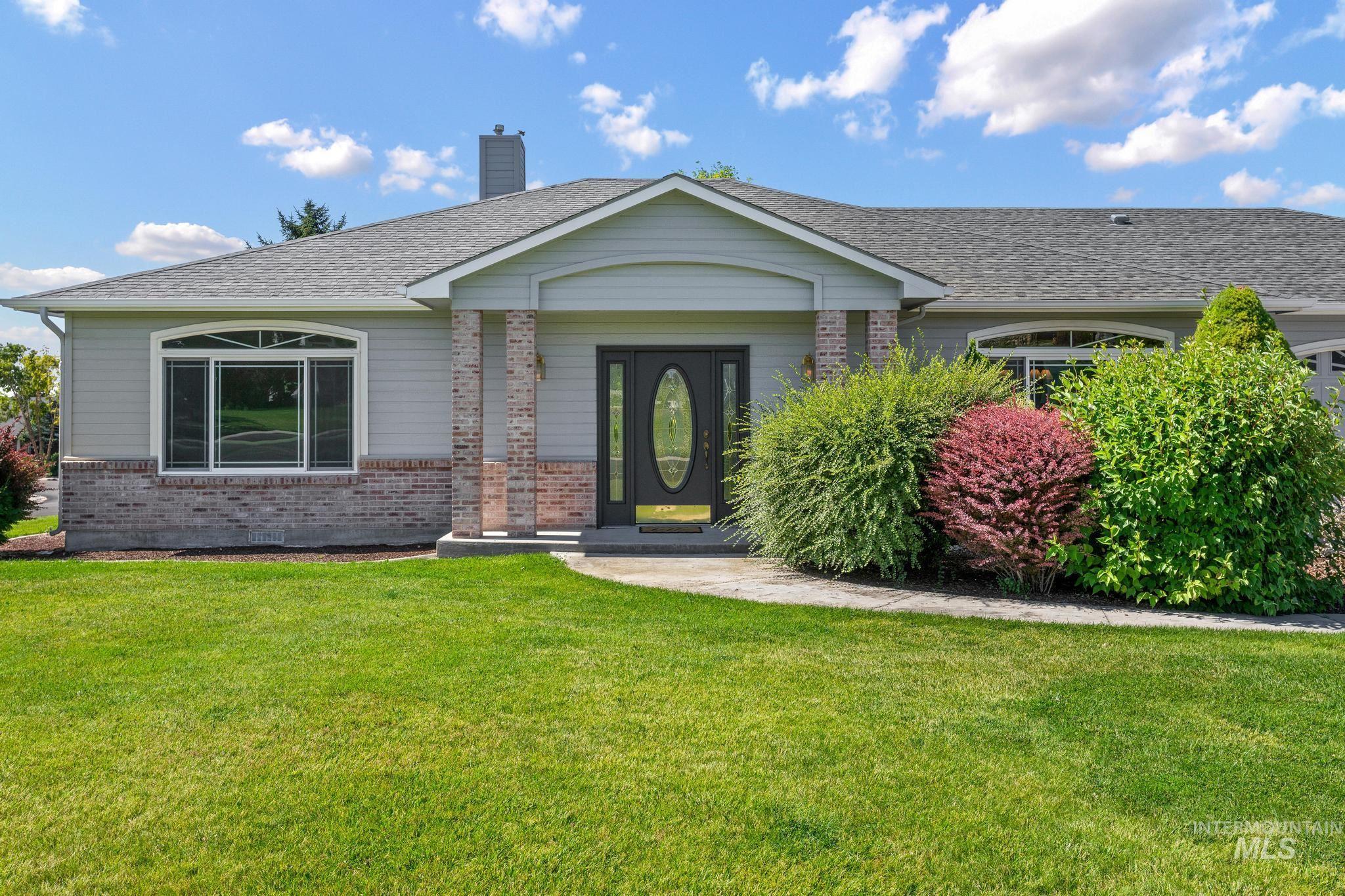 15181 Drury Way Caldwell, ID 83607 - Photo 35 of 49 Grey siding exterior with a brick skirt and matching brick columns
