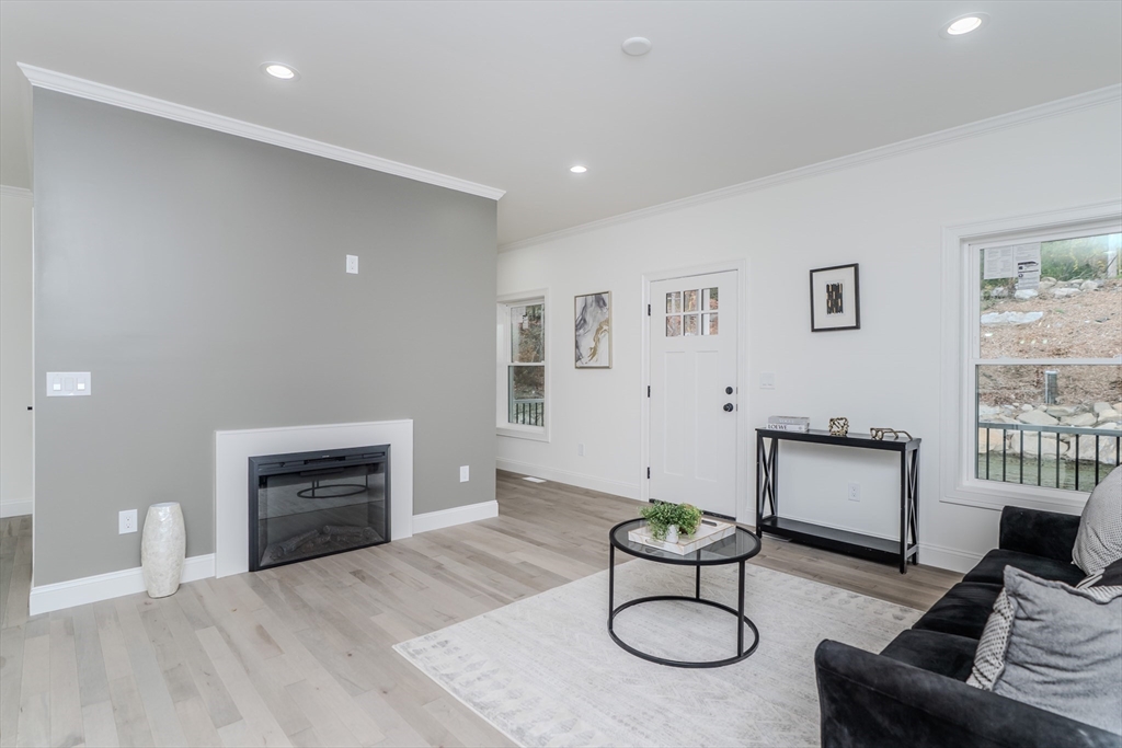135 Thompson Street Palmer, MA 01069 - Photo 11 of 39 a living room with furniture and a fireplace