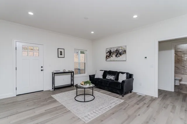 a living room with furniture and wooden floor