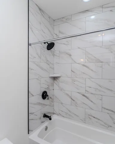 a bathroom with a tub and a shower