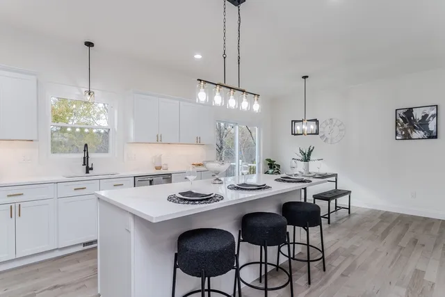 a view of a kitchen area with furniture and wooden floor