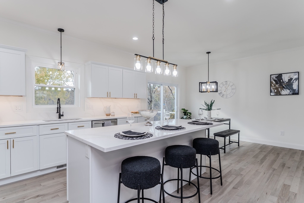 135 Thompson Street Palmer, MA 01069 - Photo 2 of 39 a view of a kitchen area with furniture and wooden floor