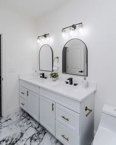 a bathroom with a double vanity sink and a mirror