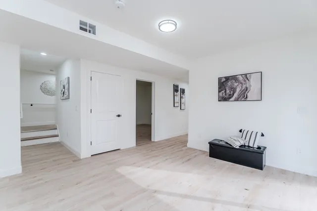 a living room with furniture and a walk in closet