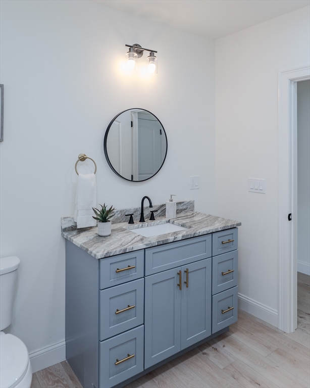 135 Thompson Street Palmer, MA 01069 - Photo 29 of 39 a bathroom with a granite countertop toilet sink and mirror