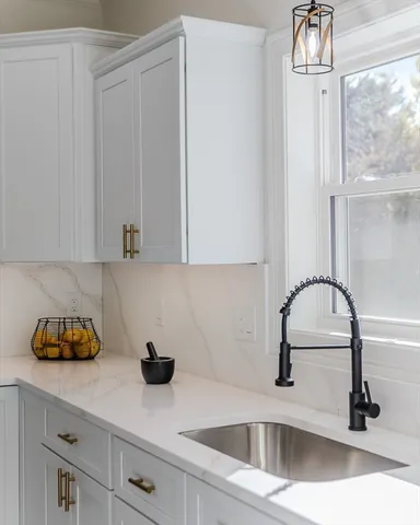 a kitchen with a sink and cabinets