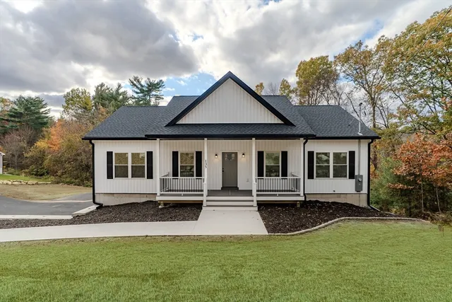 a view of a house with backyard and wooden floor