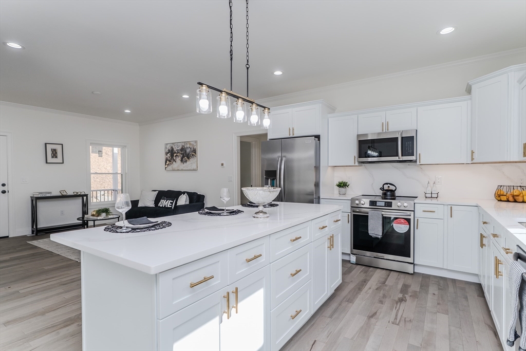 135 Thompson Street Palmer, MA 01069 - Photo 4 of 39 a kitchen with stainless steel appliances kitchen island granite countertop a sink stove and refrigerator