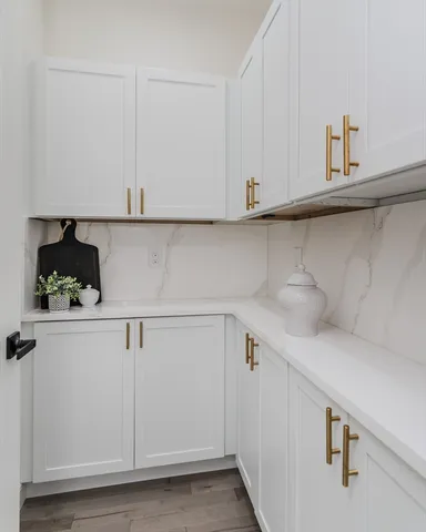 a kitchen with white cabinets and a white counter